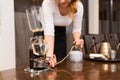 Close up of woman with siphon coffee maker and pot Royalty Free Stock Photo