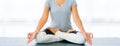 Close up woman sitting on lotus position on floor legs crossed with eyes closed for meditating. Yoga at home