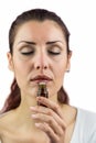 Close-up of woman smelling bottle of medicine Royalty Free Stock Photo