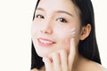 Close up woman is smiling skin beauty and health and apply white cream on face, for spa products and make up. Royalty Free Stock Photo