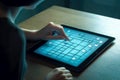 Close-up of a woman solving puzzles on a tablet. Woman using tablet computer at night. Royalty Free Stock Photo