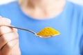 Close Up Of Woman With Spoonful Of Tumeric Powder Royalty Free Stock Photo