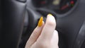 Close-up of woman switching turn signals. Action. Woman with manicure switches turn signal lever or turns on wipers