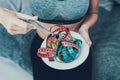 Close up. Woman with Tailors centimeter on Plate.