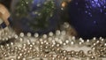 Close-up of woman taking Christmas toy. Concept. Woman's hand takes beautiful Christmas ball to decorate Christmas