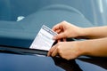 Close-up Of A Woman Taking Parking Ticket On Car`s Windshield