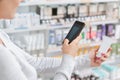 Close up a woman taking picture of product in drugstore