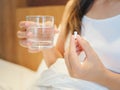 Close up of woman taking in pills with selective focus. Royalty Free Stock Photo