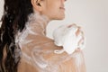 Close up woman taking shower with moisturizing soap, using puff Royalty Free Stock Photo