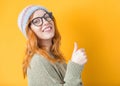 Close up woman with thumbs up, isolated on yellow background. Like concept. Yes gesturing, sings of good work Royalty Free Stock Photo