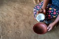 Copra coconut grater in hands of Indian woman