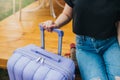 Close up of woman traveler with luggage sitting on background of cozy glamping house. Luxury camping tent for outdoor summer