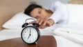 Close up woman turning off alarm clock, woken by signal Royalty Free Stock Photo