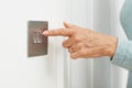 Close Up Of Woman Turning Off Light Switch