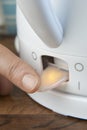 Close Up Of Woman Turning On Power Switch Of Kettle