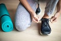 Close Up Of Woman Tying Laces Of Training Shoes Before Exercise At Home Royalty Free Stock Photo