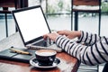 Close up woman type on laptop keyboard and looking at computer screen on table in coffee shop,Blank notebook screen mock up for Royalty Free Stock Photo