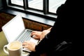 Close up woman type on laptop keyboard and looking at computer screen on table in coffee shop,Blank notebook screen mock up for Royalty Free Stock Photo