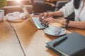 Close up of woman typing keyboard on laptop in coffee shop. People and technology concept. Freelance and Lifestyle theme. Royalty Free Stock Photo