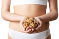Close Up Of Woman Wearing Underwear Holding Handful Of Walnuts