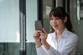 Close up woman use of smart phone, charming asian girl video call via mobile phone Royalty Free Stock Photo