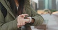 Close up of woman use of smart watch, woman wearing winter jacket at outdoor Royalty Free Stock Photo