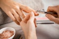 Manicurist using cuticle pusher Royalty Free Stock Photo