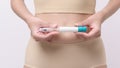 Close up woman using IVF treatment injection on belly to prepare reproductive fertility , Ovulation stimulation Royalty Free Stock Photo