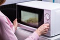 Woman Using Microwave Oven For Heating Food Royalty Free Stock Photo