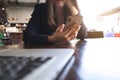 Close up of a woman using mobile smart phone on the table