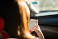 Close up woman using phone for navigator in car Royalty Free Stock Photo