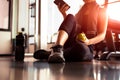 Close up of woman using smart phone and holding apple while workout in fitness gym. Sport and Technology concept. Lifestyles and
