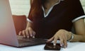 Close up woman using smartphone and laptop computer on white desk. Tachnology and business concept Royalty Free Stock Photo