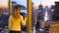 CLOSE UP: Woman views the breathtaking evening landscape of New York City.