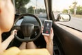 Close-up of woman voice messaging behind the wheel