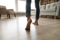 Close up of woman walking barefoot on warm wooden floor Royalty Free Stock Photo