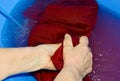 a woman washes clothes in a blue basin Royalty Free Stock Photo