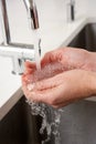 Close Up Of Woman Washing Hands At Kitchen Sink