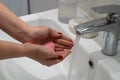 close up woman washing hands with soap and water, white foam, in the bathroom, under tap in the sink, Royalty Free Stock Photo