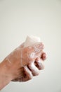 Close up of woman washing her hands with a bar of soap and soapy suds Royalty Free Stock Photo