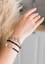 Close-up woman wearing beautiful luxury bracelets. Handmade jewellery and accessories Royalty Free Stock Photo