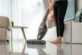 Close up of  woman wearing casual clothes  is cleaning house floor in living room using the vacuum cleaner at home during Staying Royalty Free Stock Photo