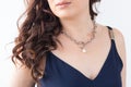 Close-up woman wearing luxury pearl pendant and silver necklaces - jewellery and accessories concept Royalty Free Stock Photo