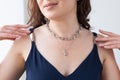 Close-up woman wearing luxury pendant and silver chain - jewellery and accessories concept Royalty Free Stock Photo