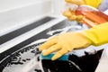 Close Up Of Woman Wearing Rubber Gloves Cleaning Kitchen Hob Royalty Free Stock Photo