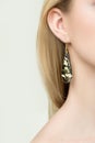 Close up of woman wearing shiny diamond earrings Royalty Free Stock Photo