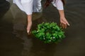 Close-up of woman in white dress in the water. Art Woman with wreath in river. Wet witch Girl in the lake Royalty Free Stock Photo