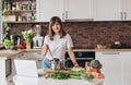 Close up woman in white t-shirt cooking soup with fresh vegetables in kitchen at home. Menu, recipe book banner. Girl Royalty Free Stock Photo