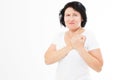 Close up of woman who has chest pain, isolated on white - middle aged woman feeling heart pain and holding her chest