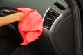 Close up of woman wiping car interior with red rag